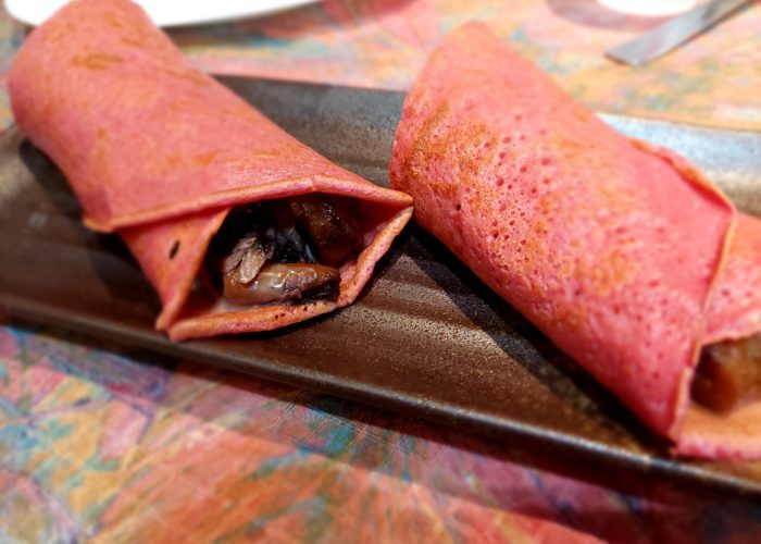 crêpe rose roulée avec des morceaux de viande